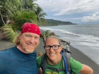 Two people taking a selfie on a beach in costa rica.